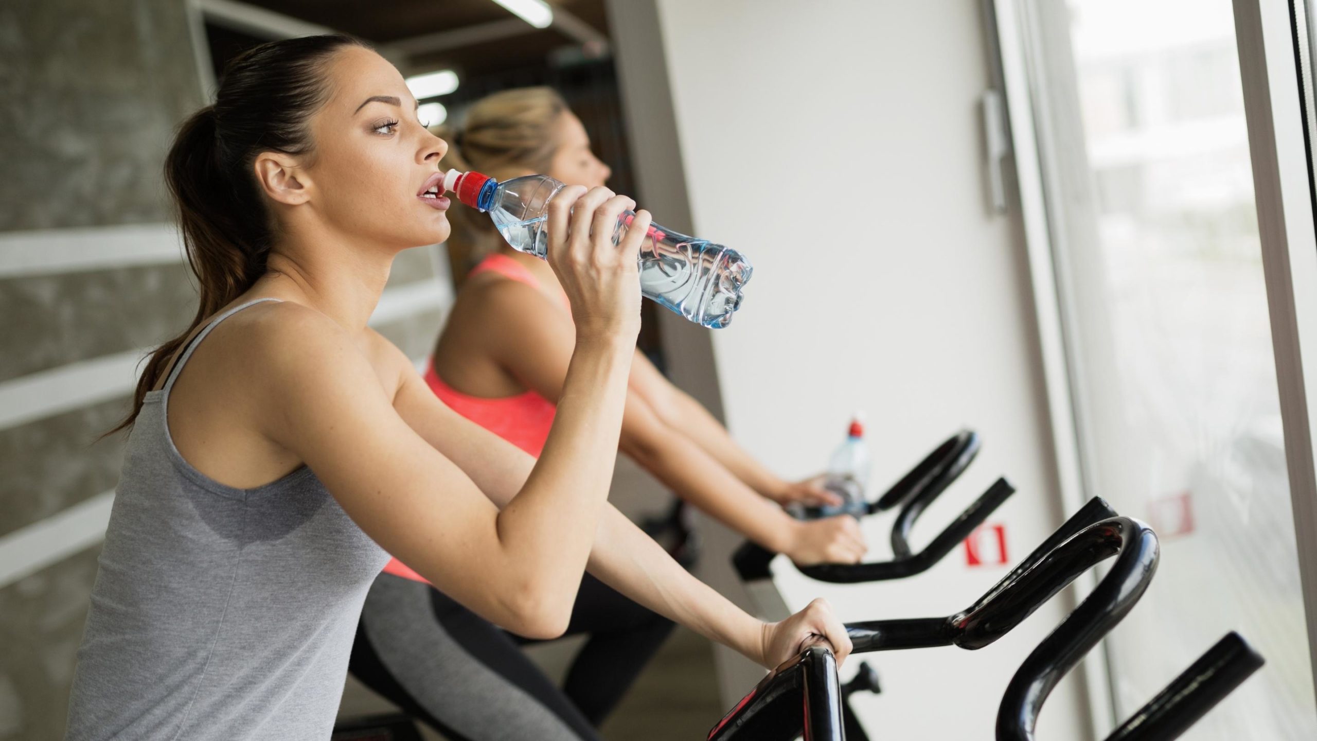 woman keeping herself hydrated during workout