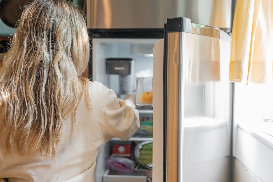 Woman getting something from her freezer