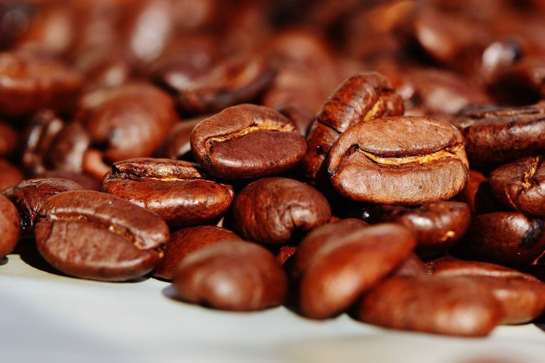 Pile of coffee beans on a white table