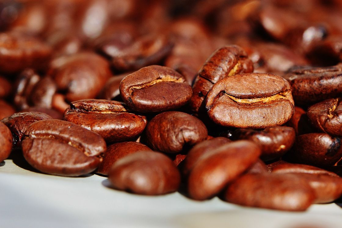 Pile of coffee beans on a white table