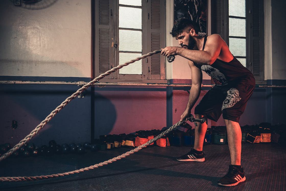 Man doing battle rope exercises