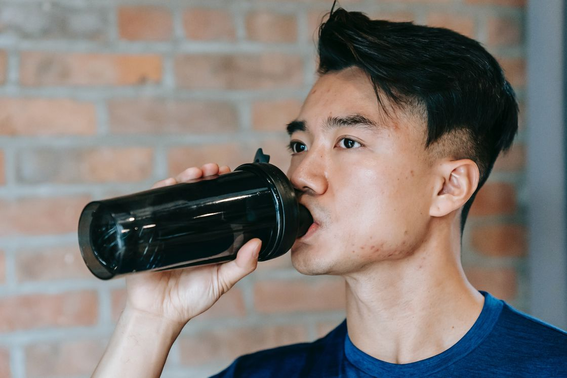 Man drinking from his black tumbler