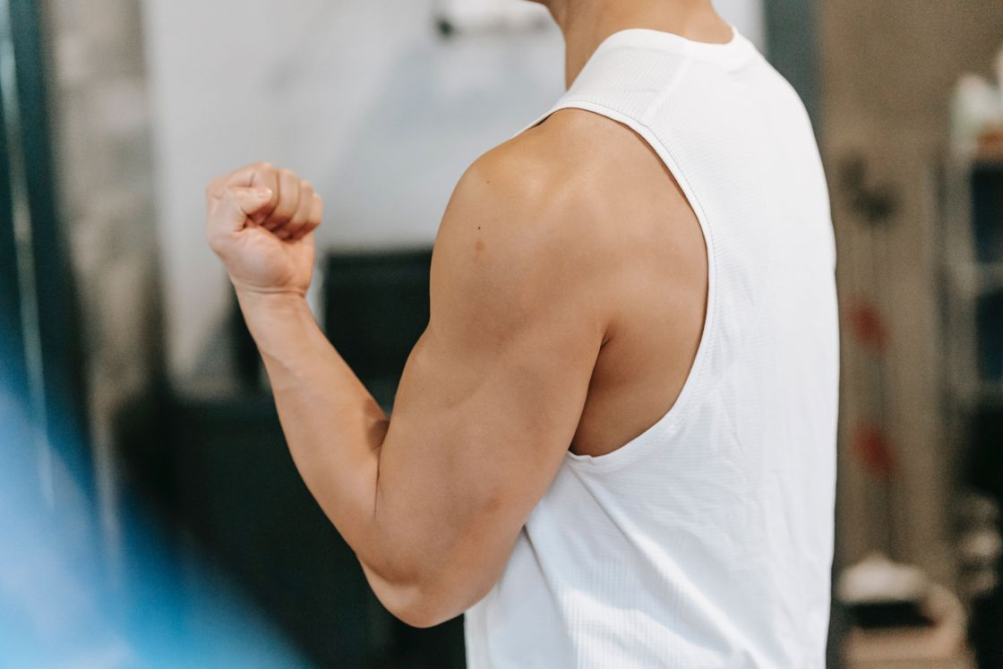 Man flexing his arm muscles after exercising