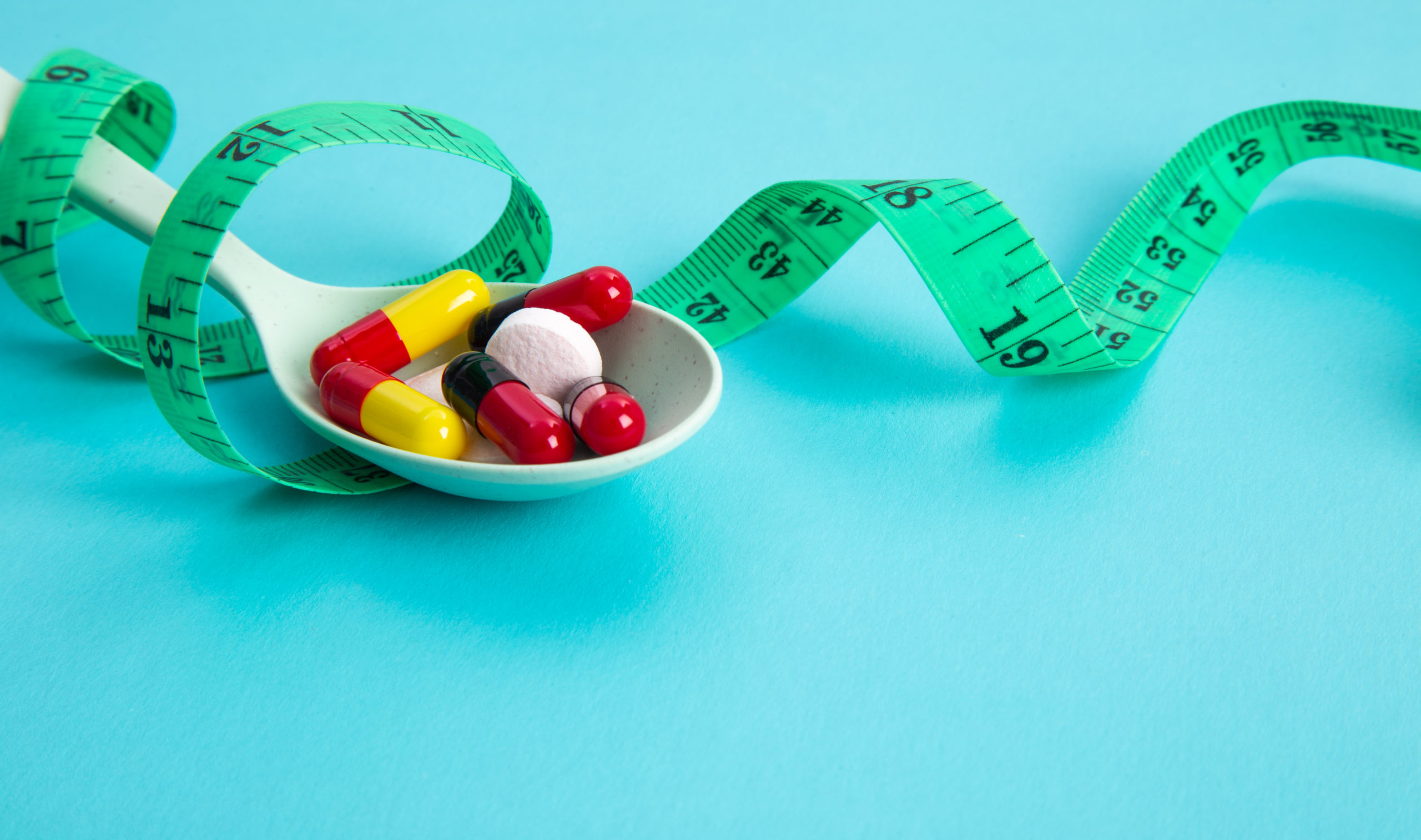 diet pills and measuring tape