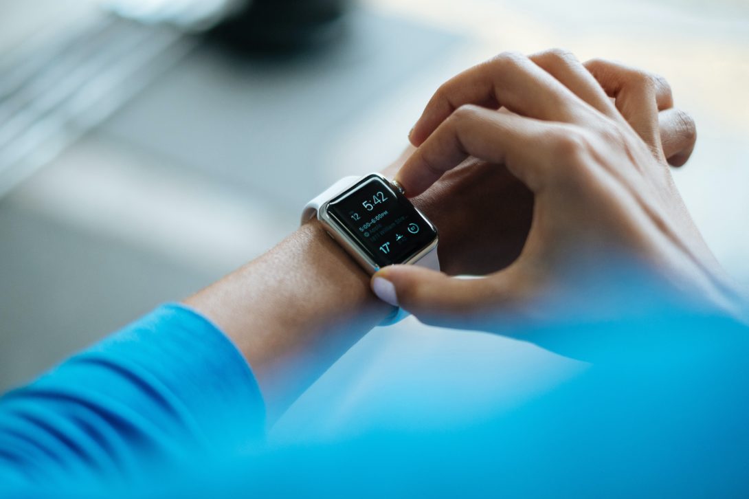 A woman pressing her smart sports watch