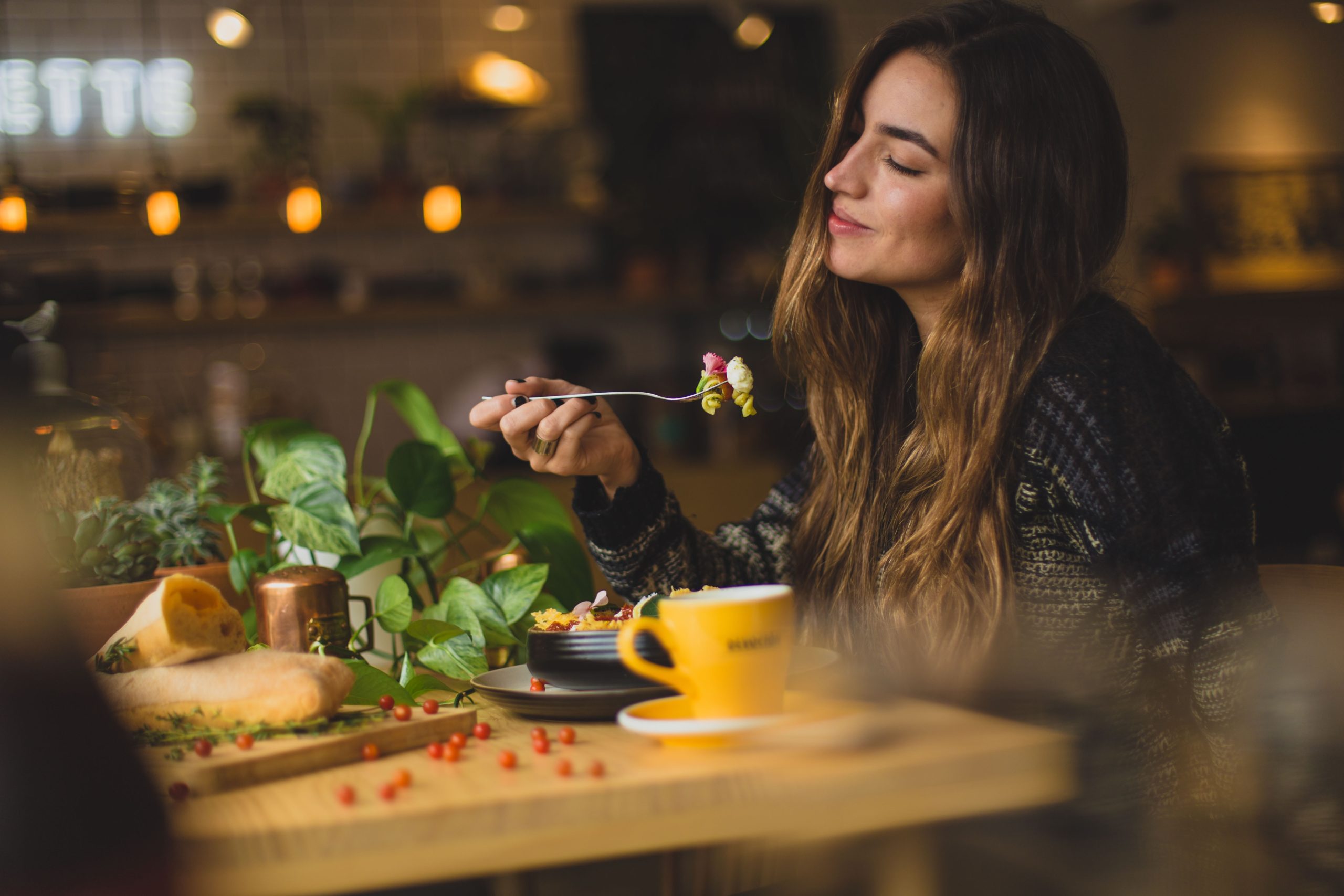 A woman eating on a coffee shop