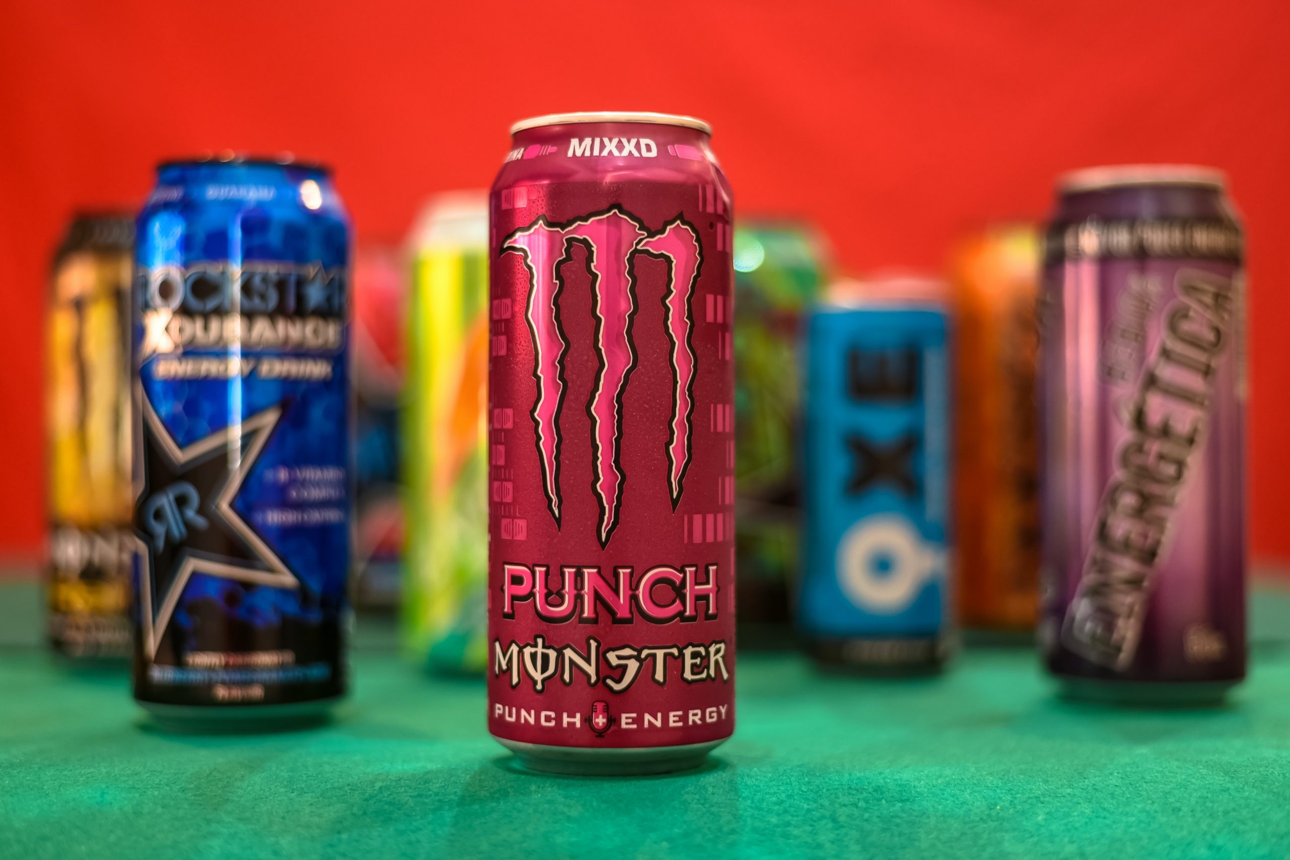 Different brands of energy drink with the Monster Punch energy drink at the center