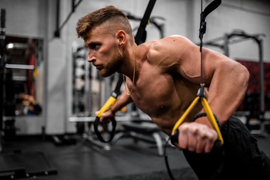 Man using pull up resistance bands at the gym