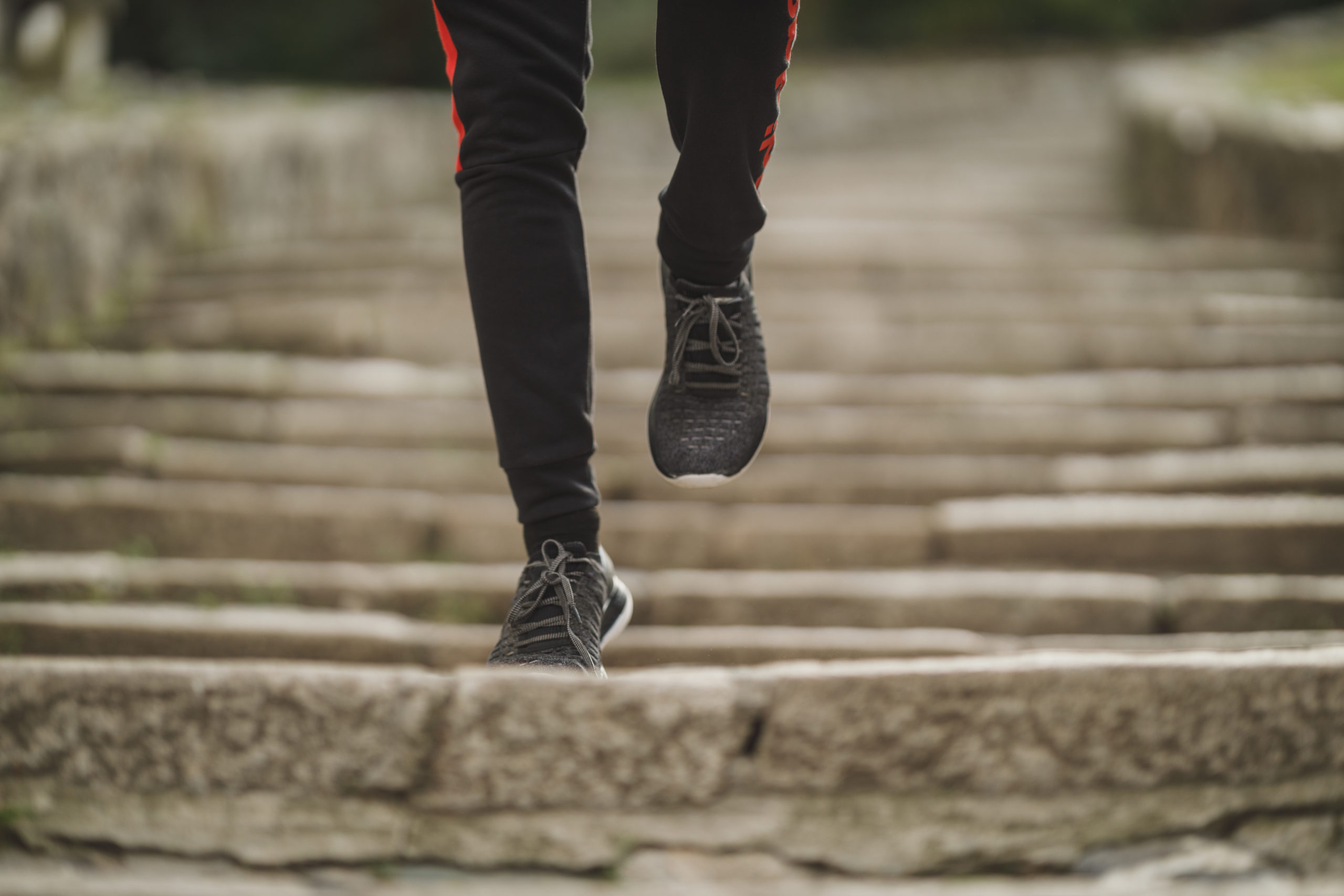 Feet of a man jogging on the stairs