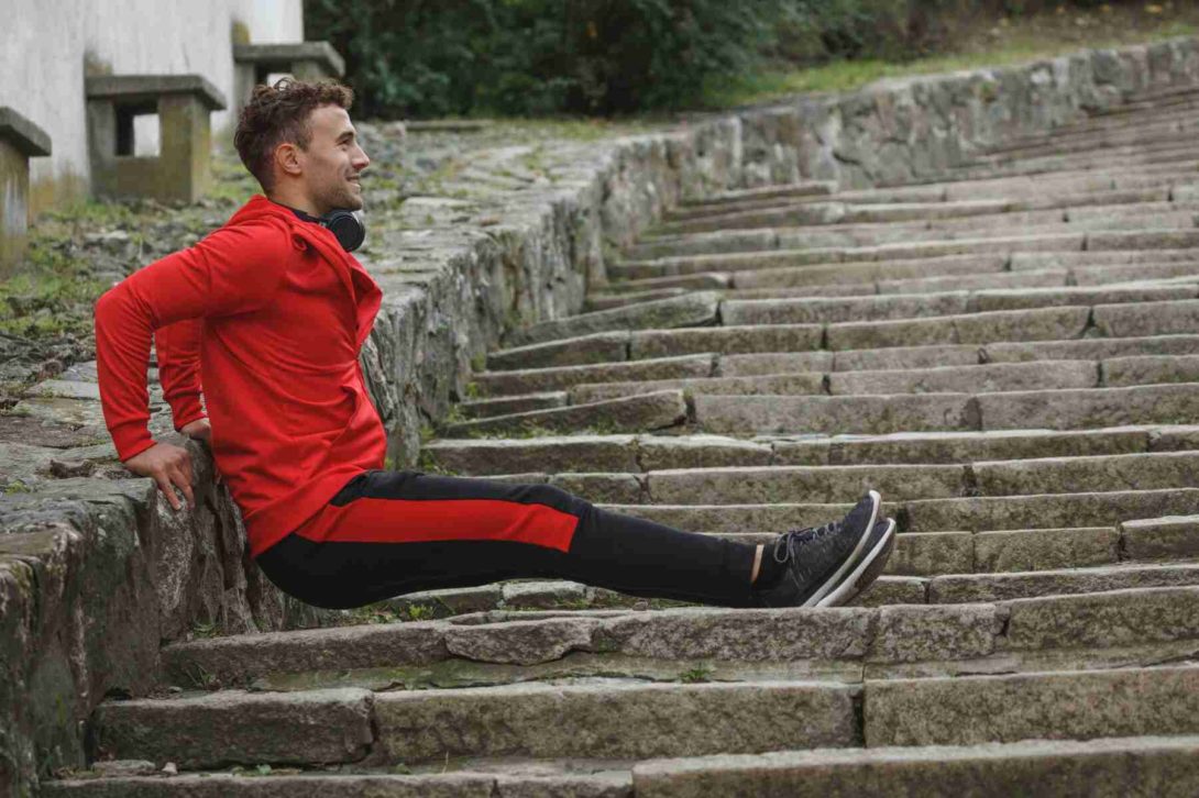 A man exercising on a stairs outside
