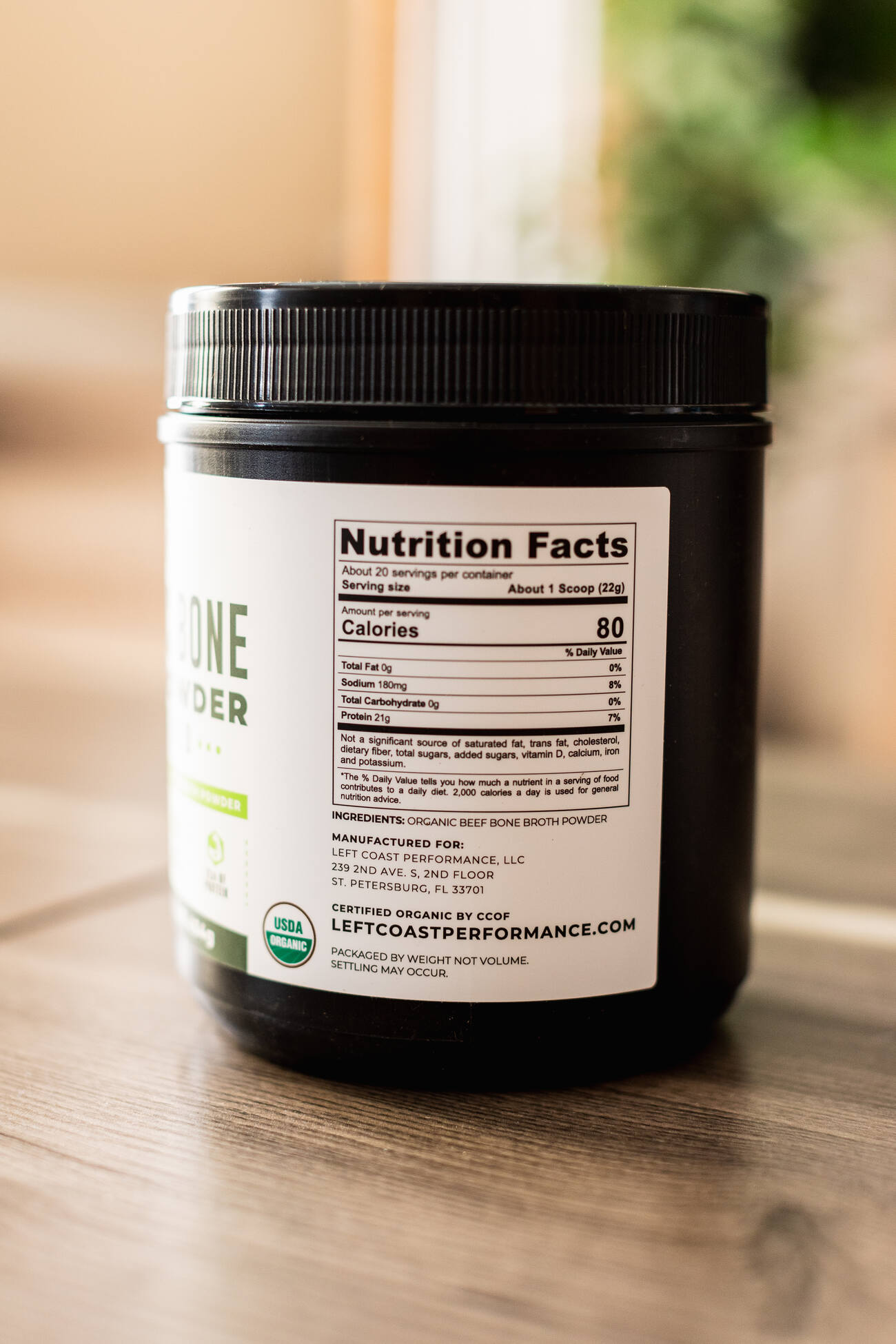 A container of "ONE PROTEIN" powder with nutritional facts on the label