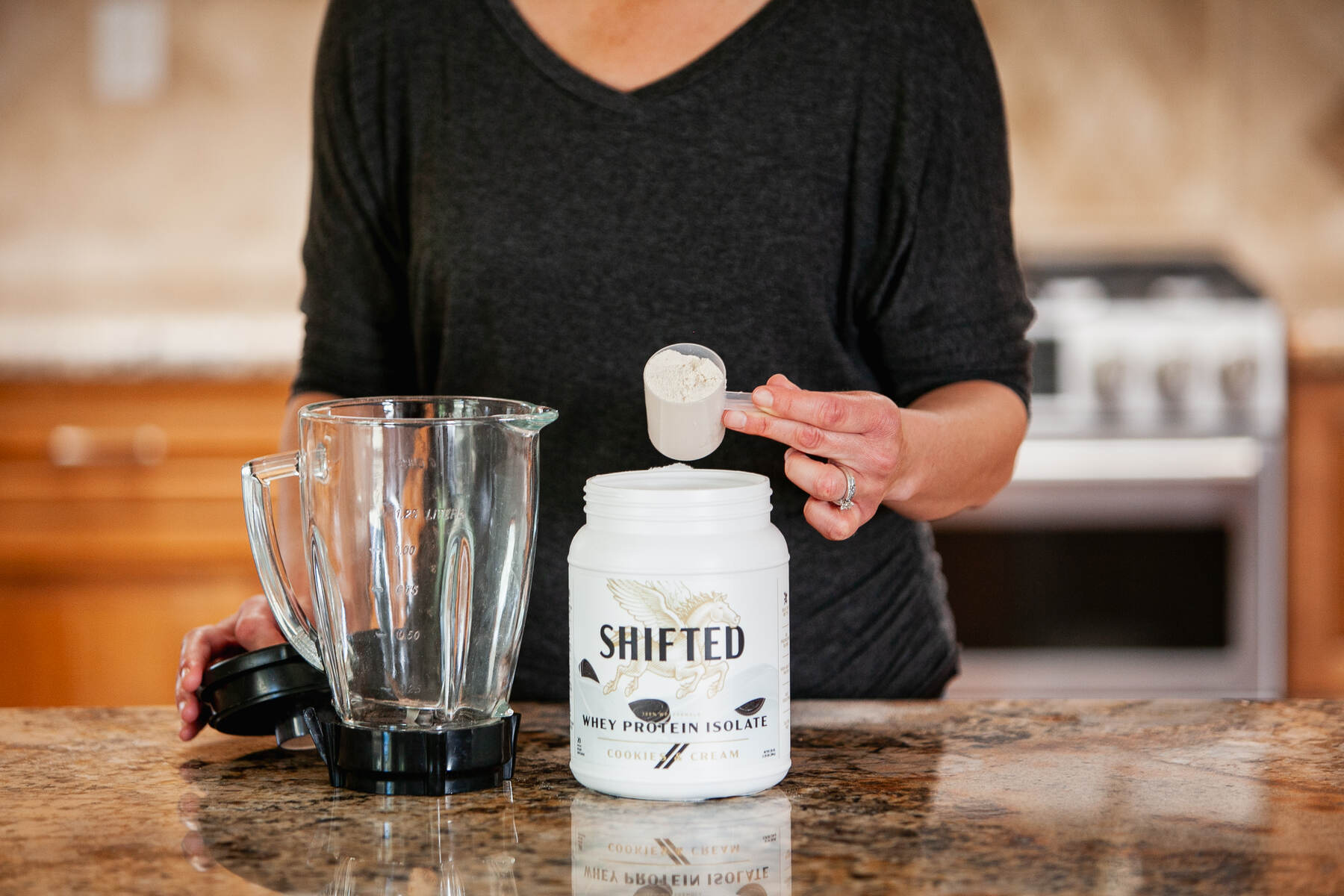 A woman preparing a shake with whey protein isolate