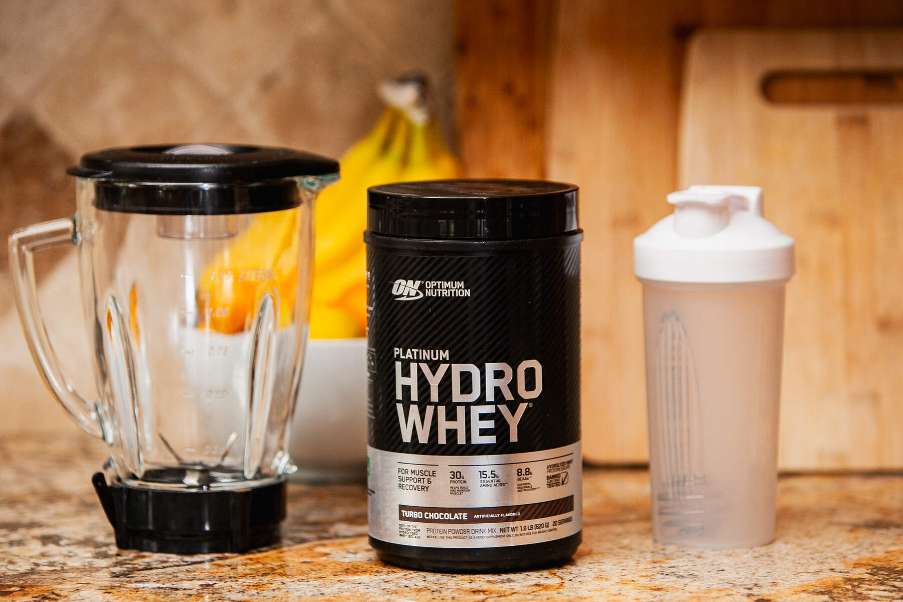 Kitchen counter with hydrolyzed whey protein, blender, and shaker